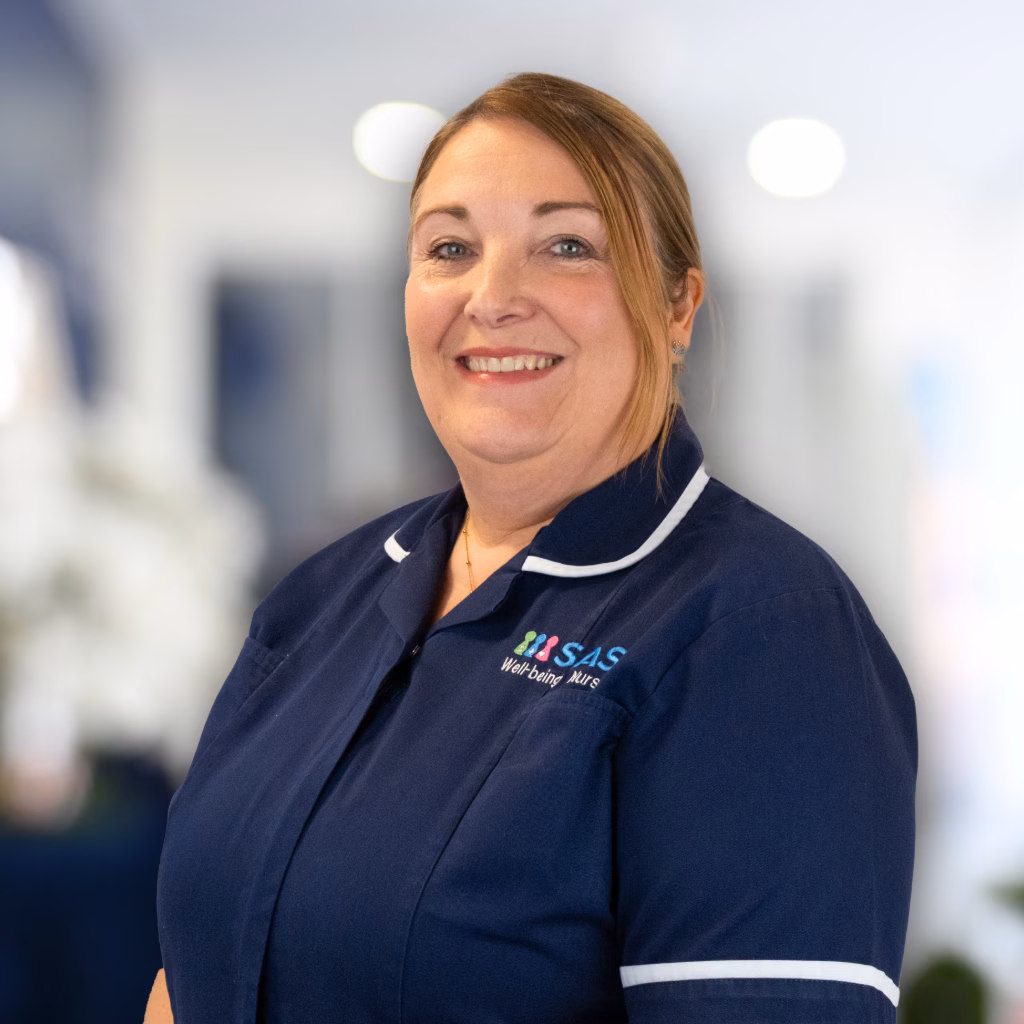 Louise in nurse uniform in front of an office background