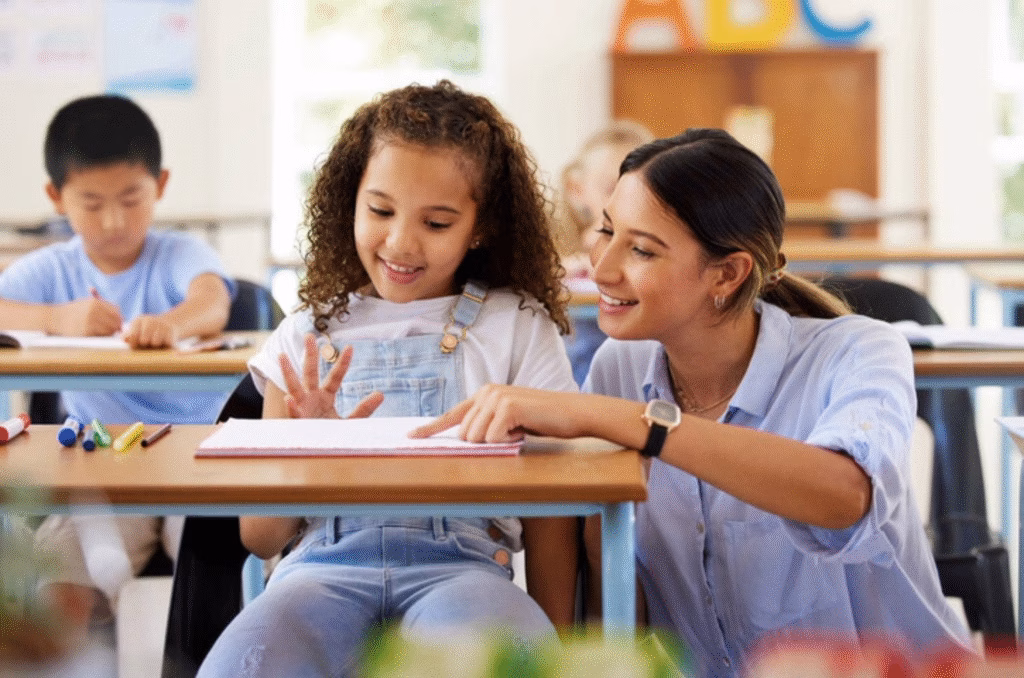 Teacher with a student helping her with work