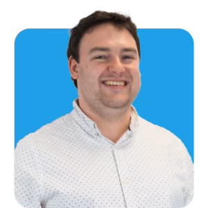 a headshot of a man smiling in front of a blue background