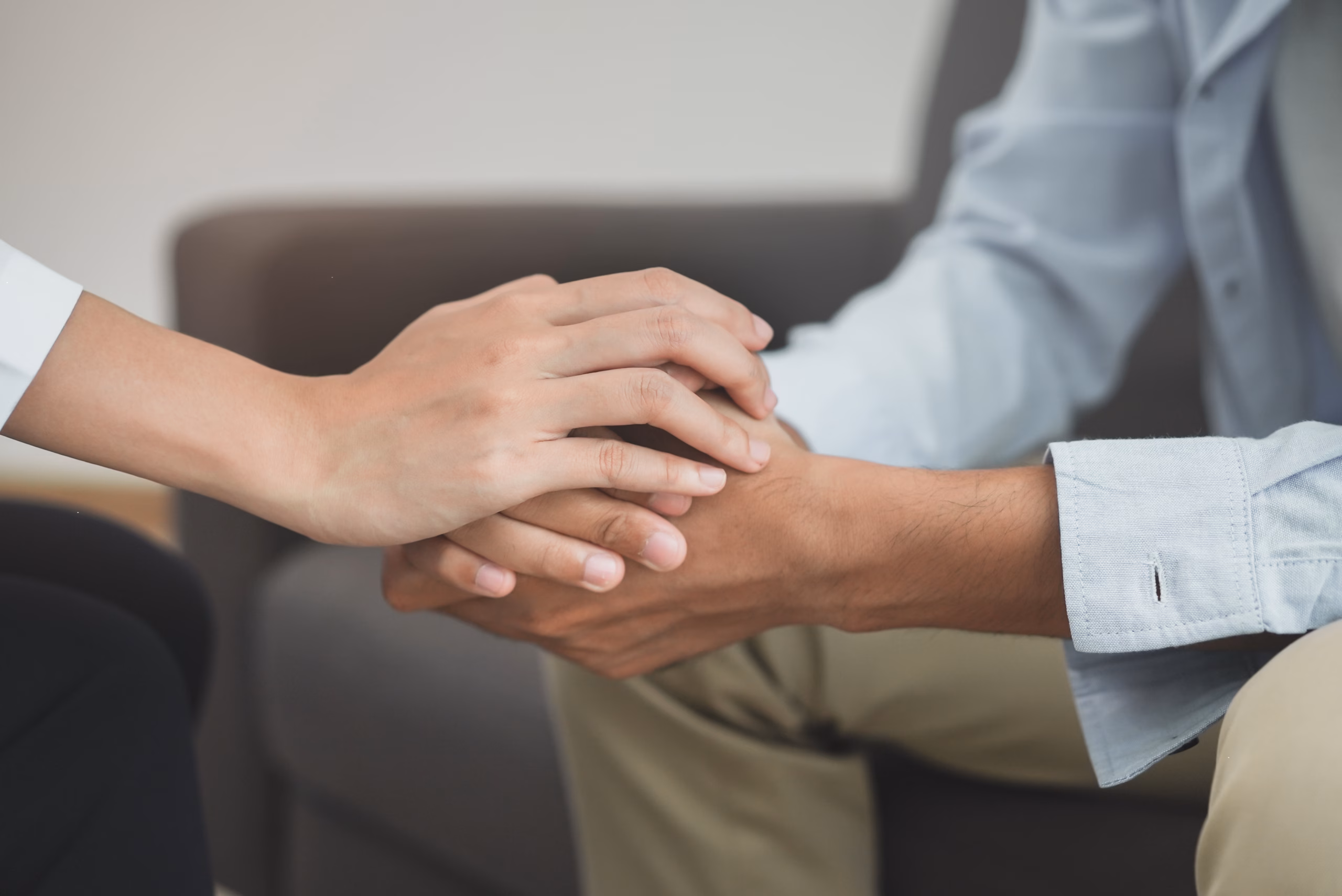 hand holding hand counselling session setting