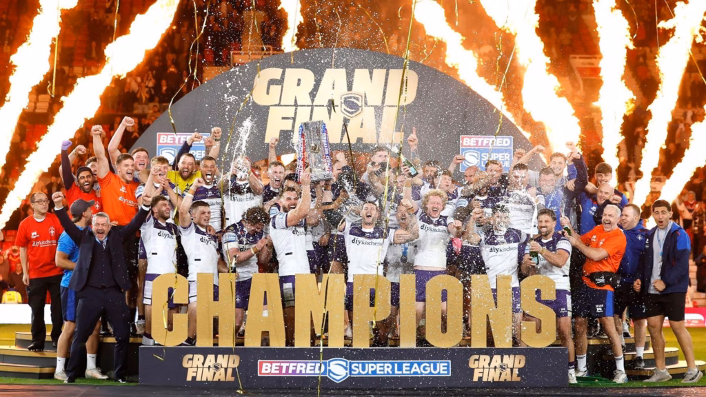 A team photo of Wakefield Trinity celebrating becoming champions of the Betfred Super League Grand Final