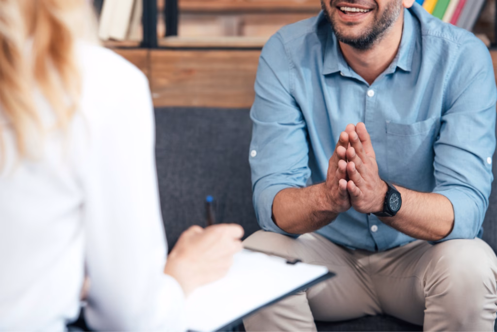 Man sat in therapy laughing
